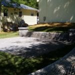 exterior photo of short stone wall and patio